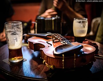 Irische Fiddle mit Biergläsern im Pub